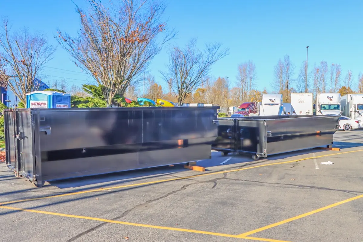 Professional dumpster rental service with roll-off container on residential driveway in Church Hill